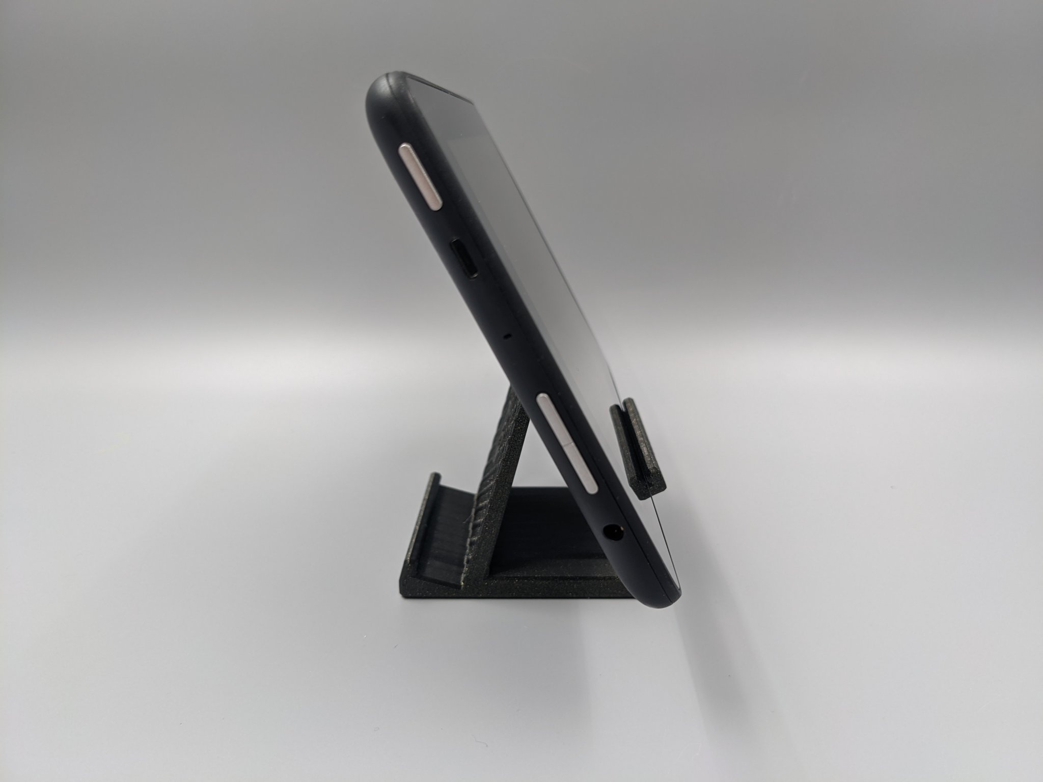 Giá đỡ điện thoại hình lục giác với lỗ sạc