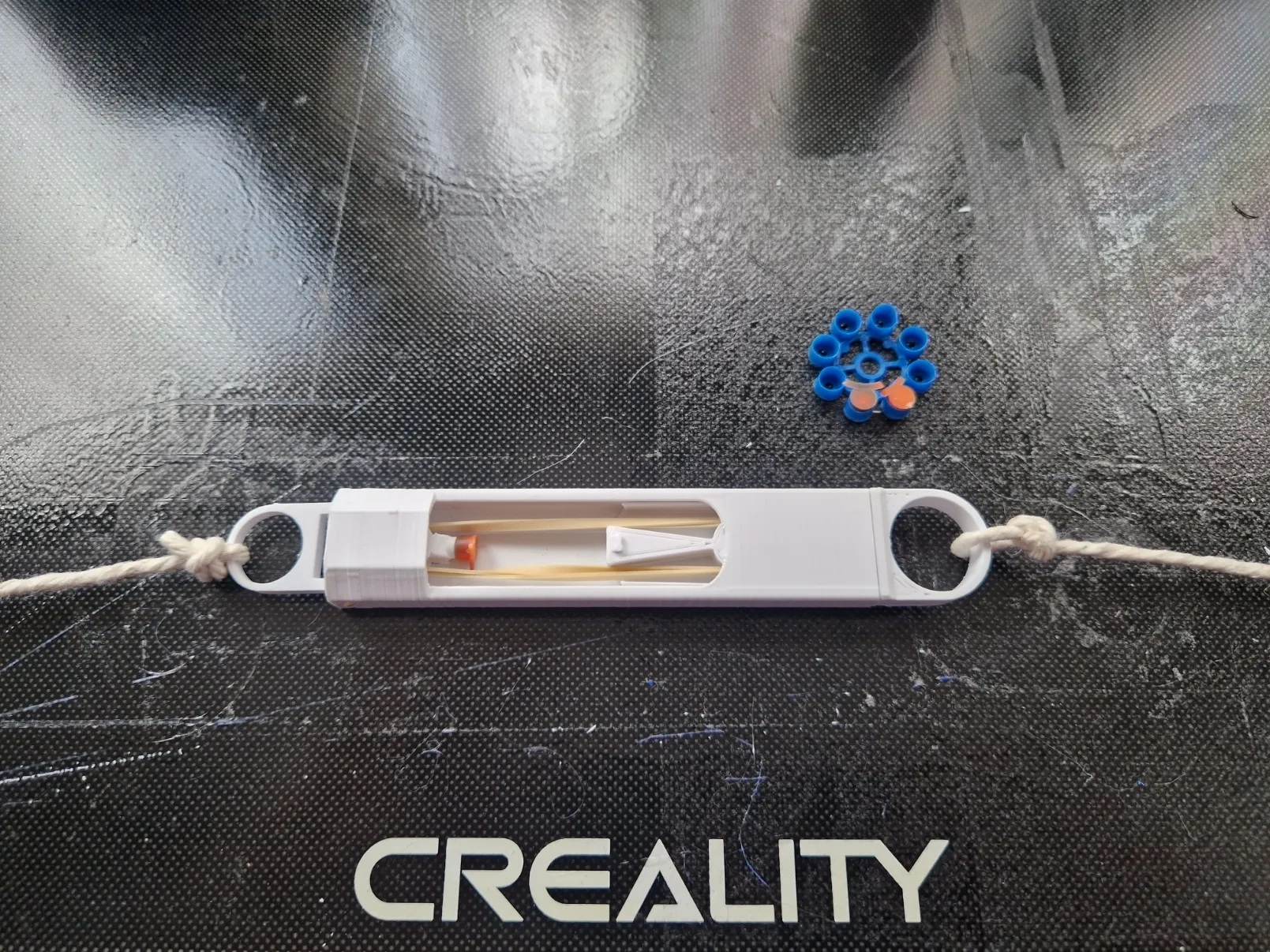 Bẫy dây trip wire sử dụng nắp súng cao su