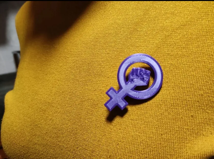 Bông cài áo với biểu tượng phong trào nữ quyền