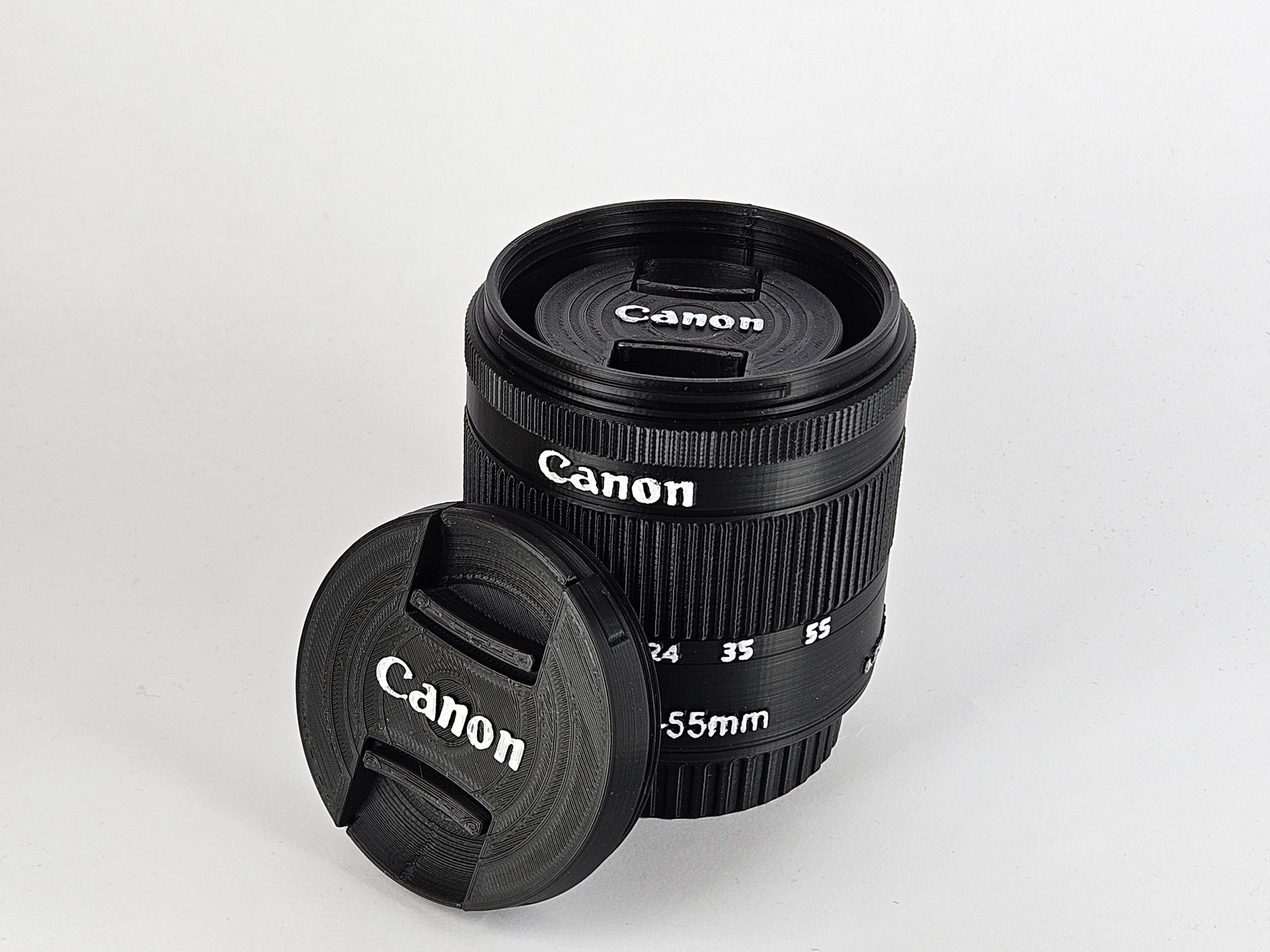 Hộp đựng ống kính Canon EF-S 18-55mm và giá đỡ bút